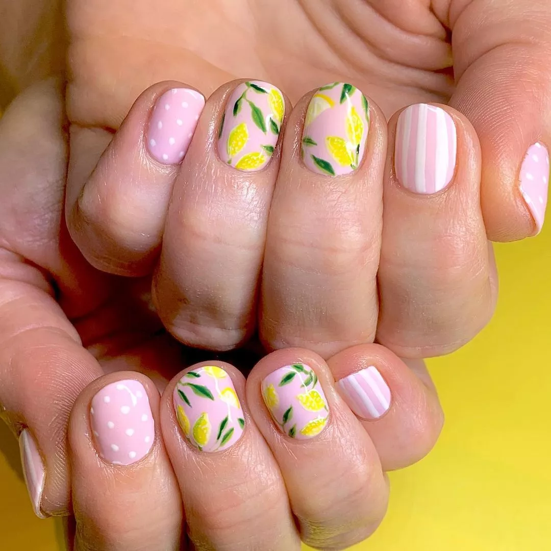 baby pink nails with lemons, polka dot, and stripe designs