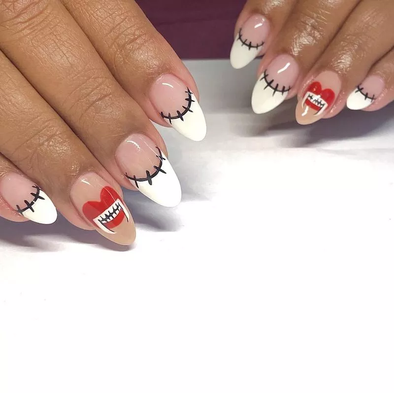 French manicure with stitched tips and vampire mouth accent nails