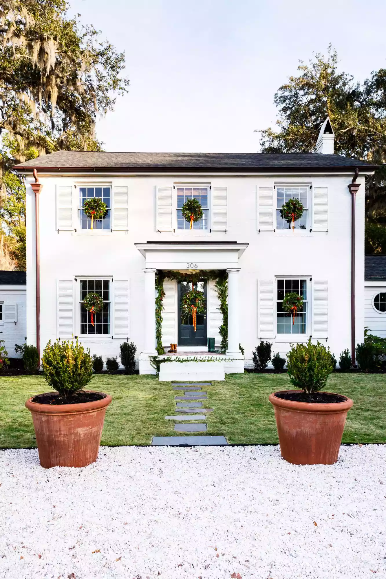 White Foursquare House in Charleston, SC with Wreaths on Windows for Christmas