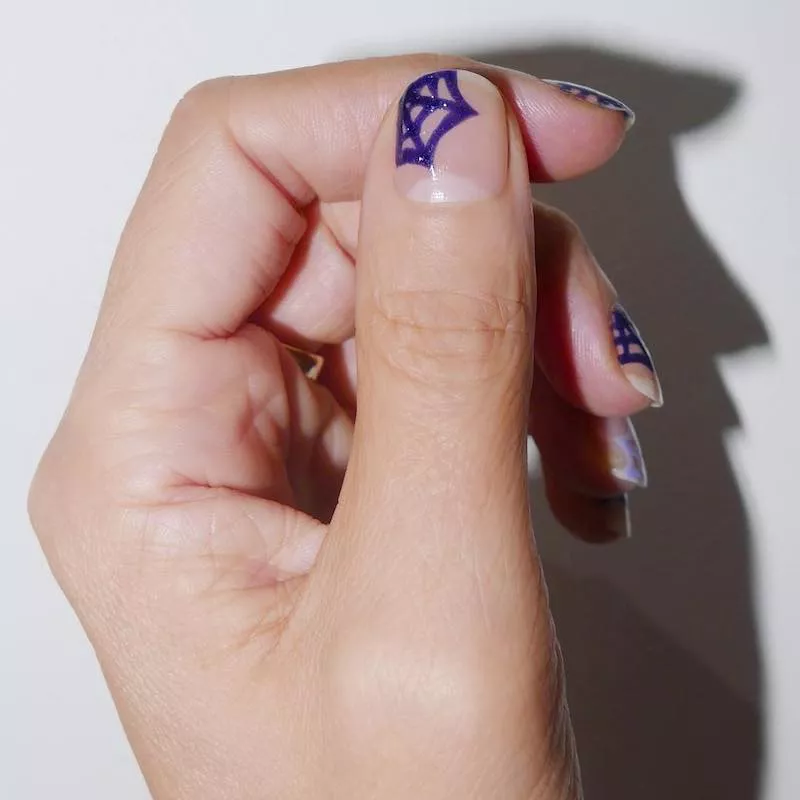 Negative space nails with indigo spider webs