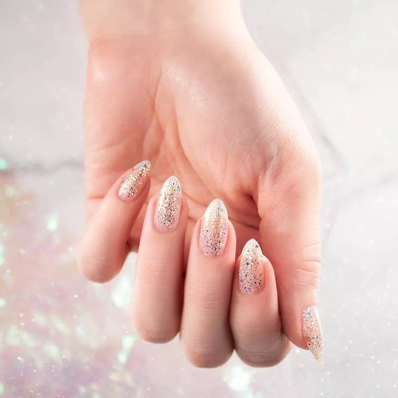 Clear manicure with silver sparkles and almond shape