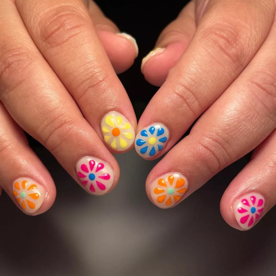 Natural nails with gel cream base and festive floral art
