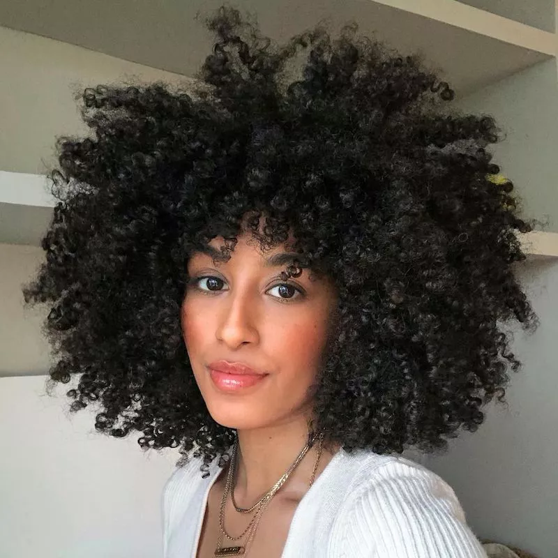 Woman with a defined curly Afro hairstyle