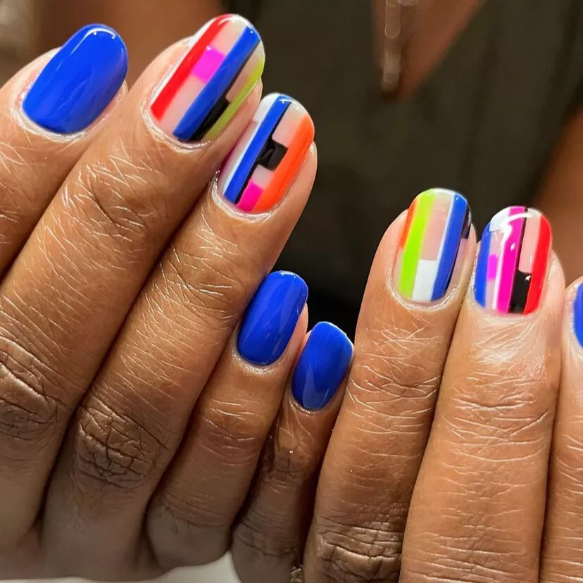 abstract art on nails with royal blue as the base color