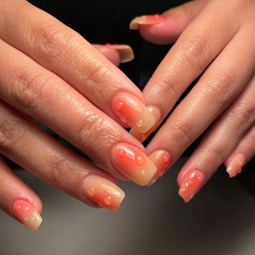 orange ombre, squoval shaped nails with 3d dew drop accents
