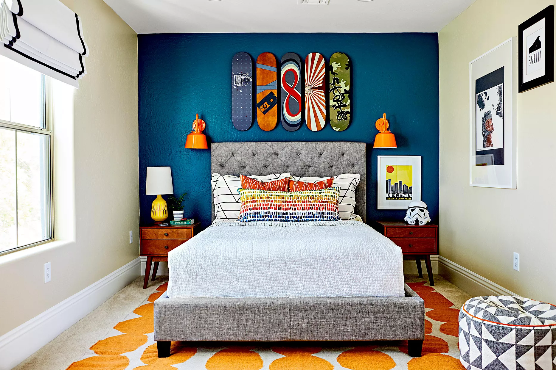 Bedroom with colorful pillows and skateboards