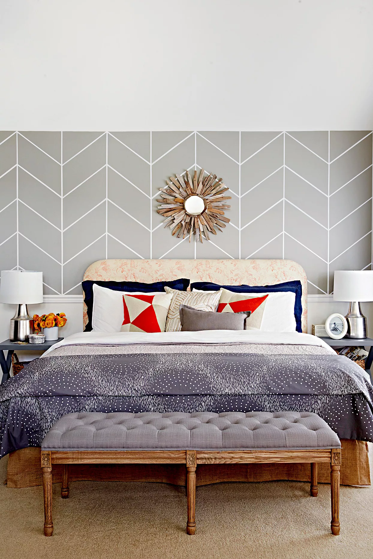 Bedroom with geometric gray walls and gray bedspread