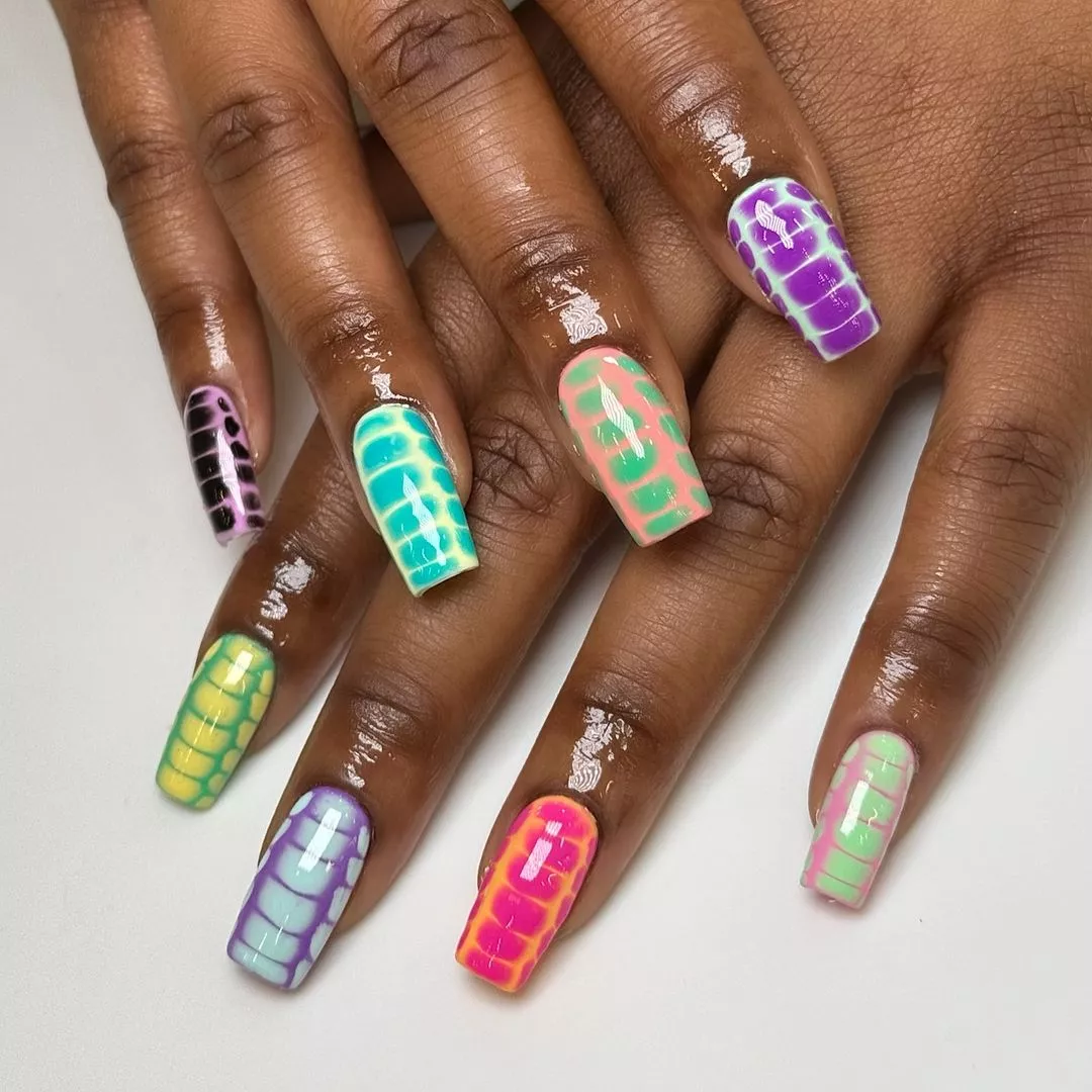 Crocodile print nails with a mix of pastel and bold colors