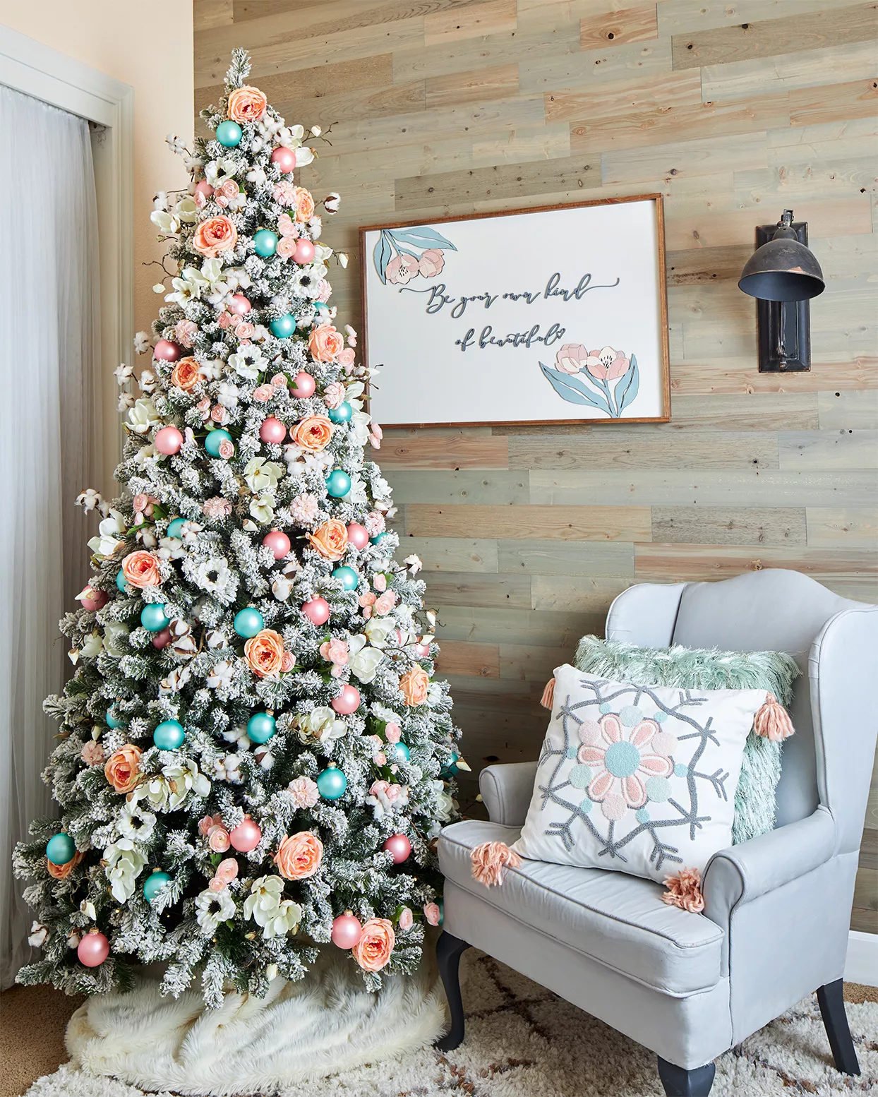 gray armchair next to christmas tree decorated with flowers