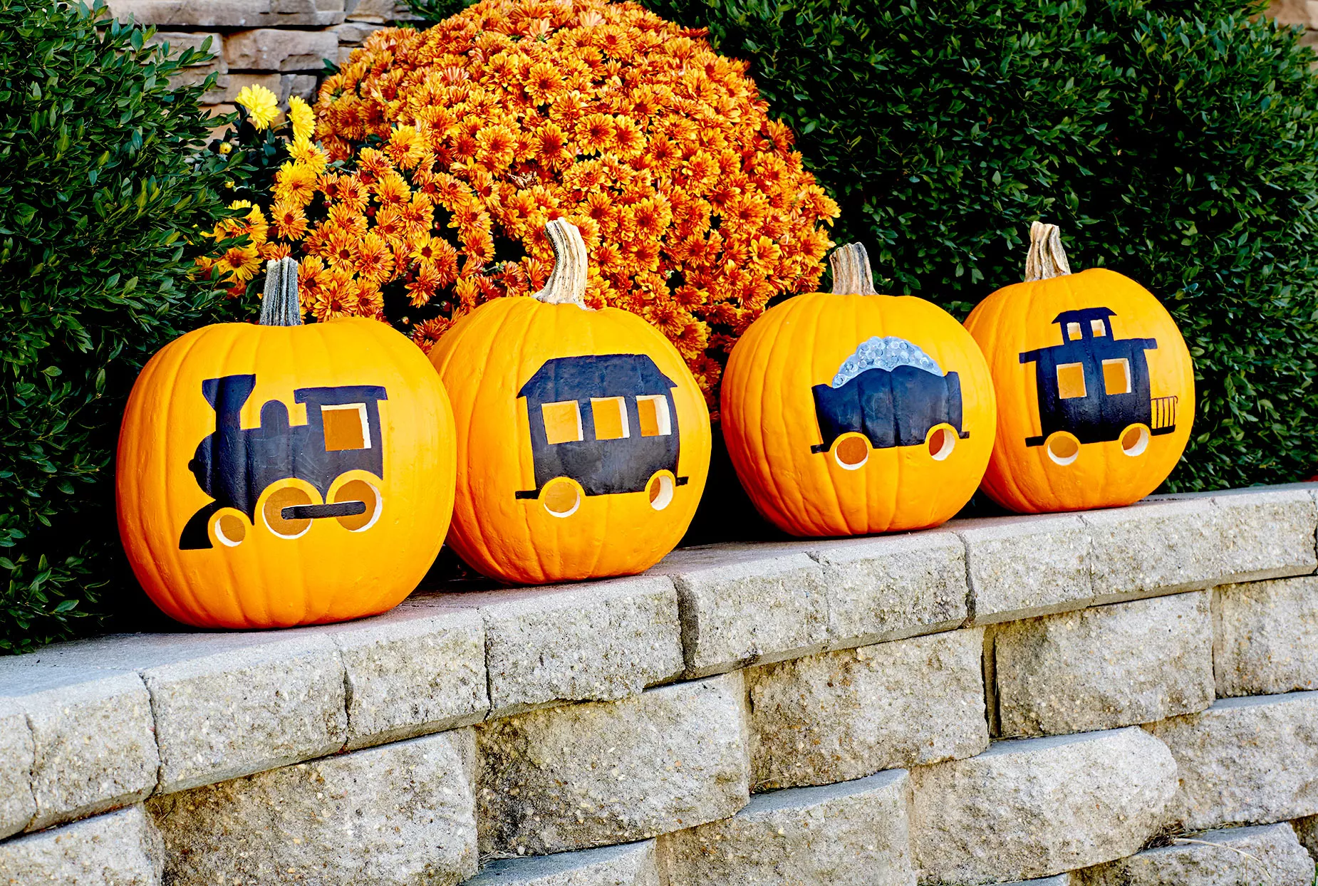 Four pumpkins with train carving and paintings
