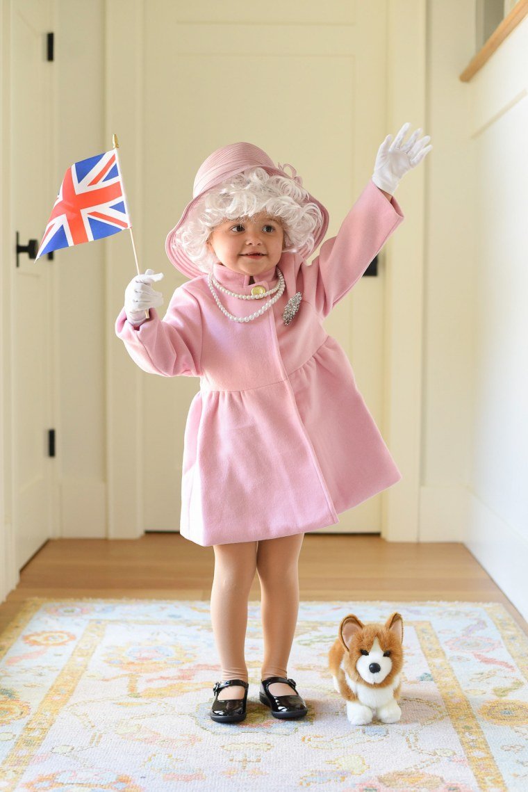 little girl dressed in a queen elizabeth costume