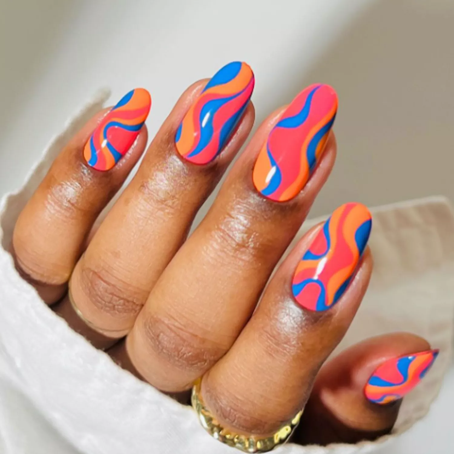 peach, blue, and papaya swirl nails
