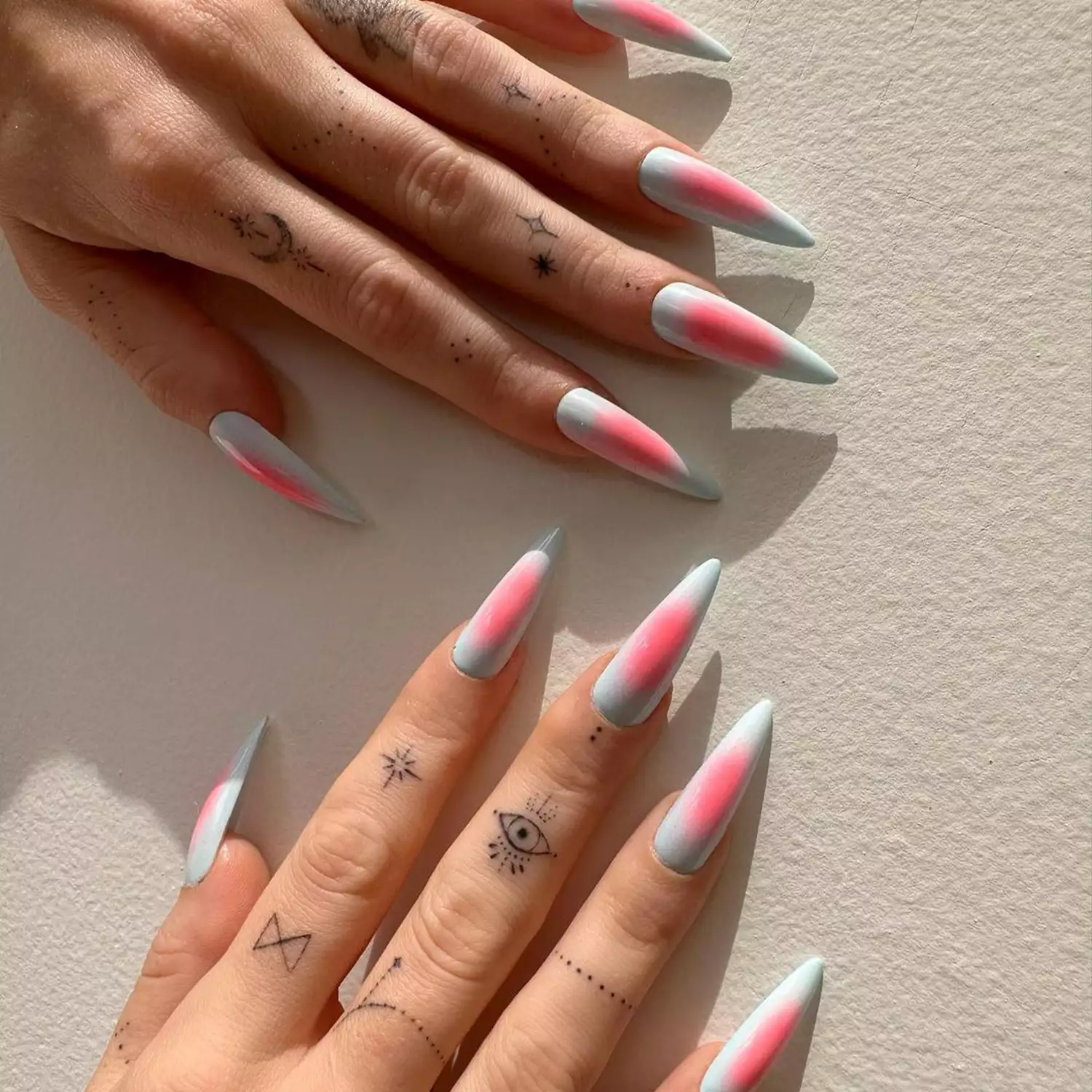 baby blue and pink aura stiletto nails