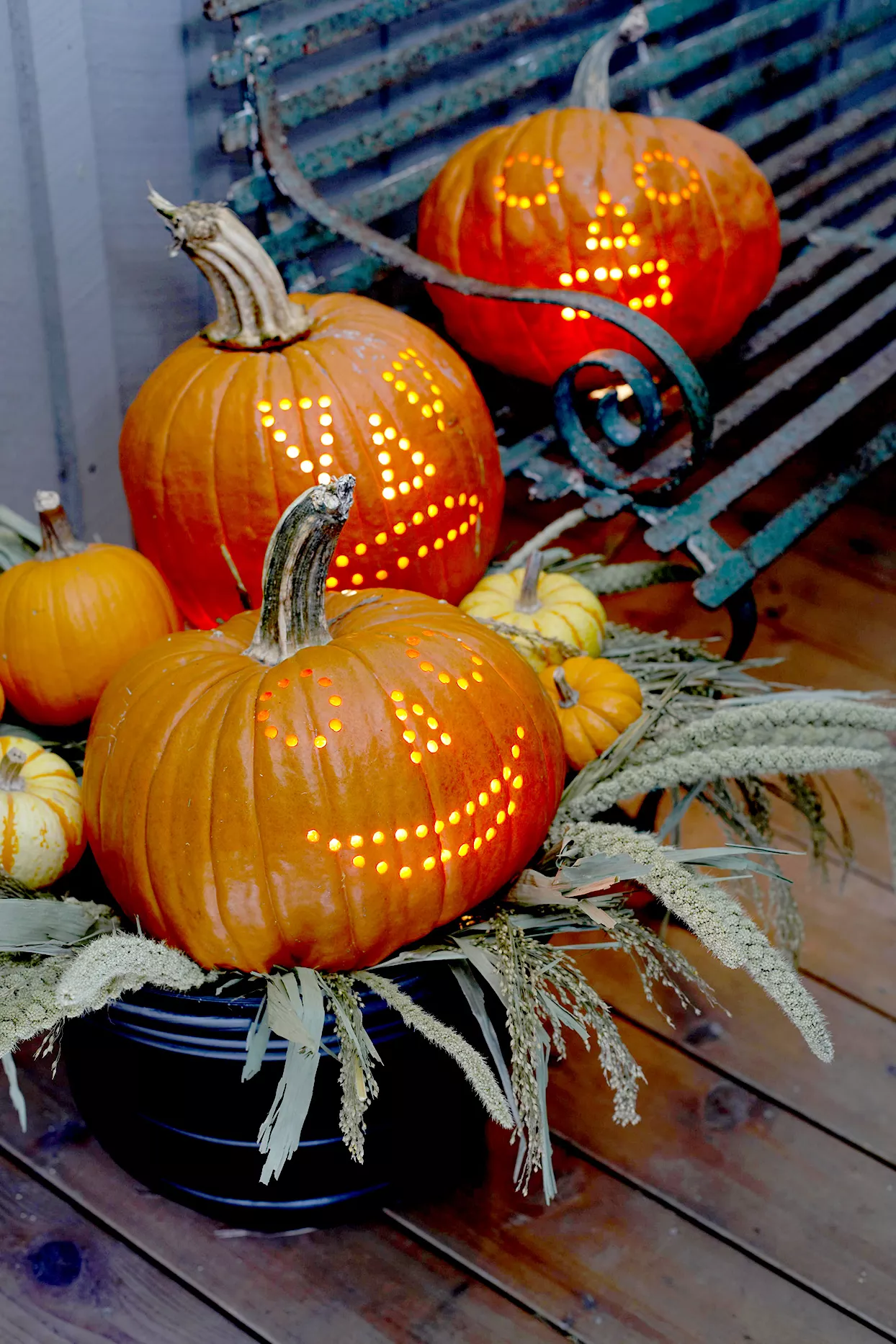 Three pumpkins carved with drill holes