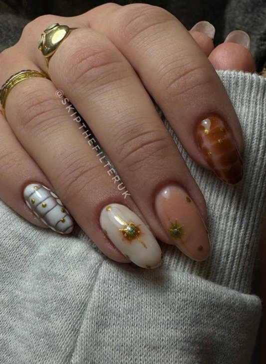neutral almond nails with brown and gold