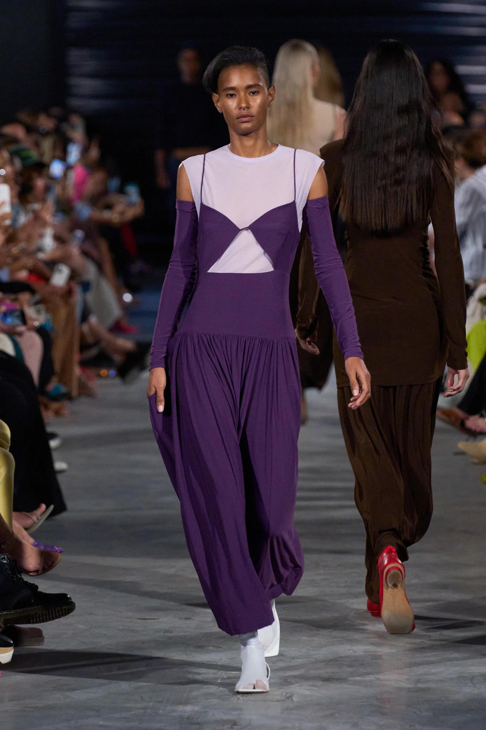 A model wearing a purple dress, a big 2023 spring trend, on the Tibi runway.