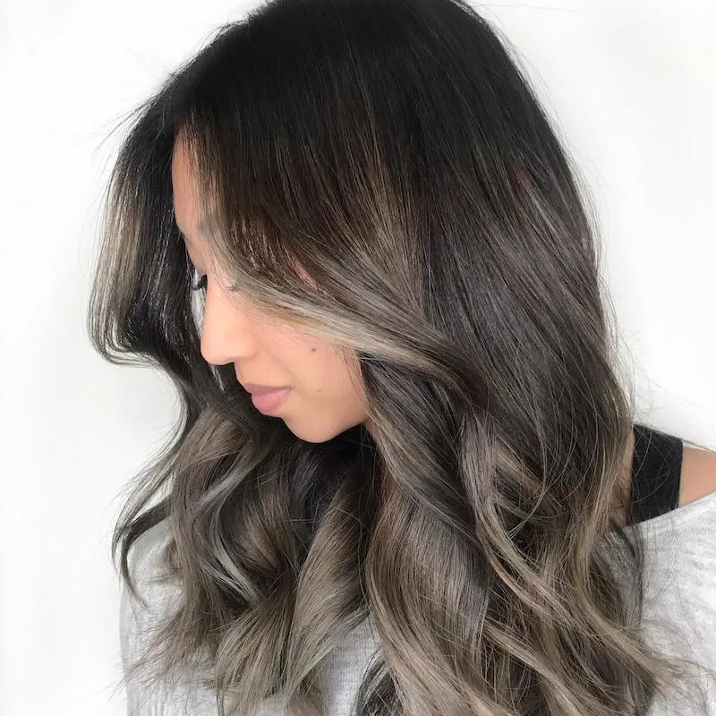 Woman with ash blonde face-framing highlights