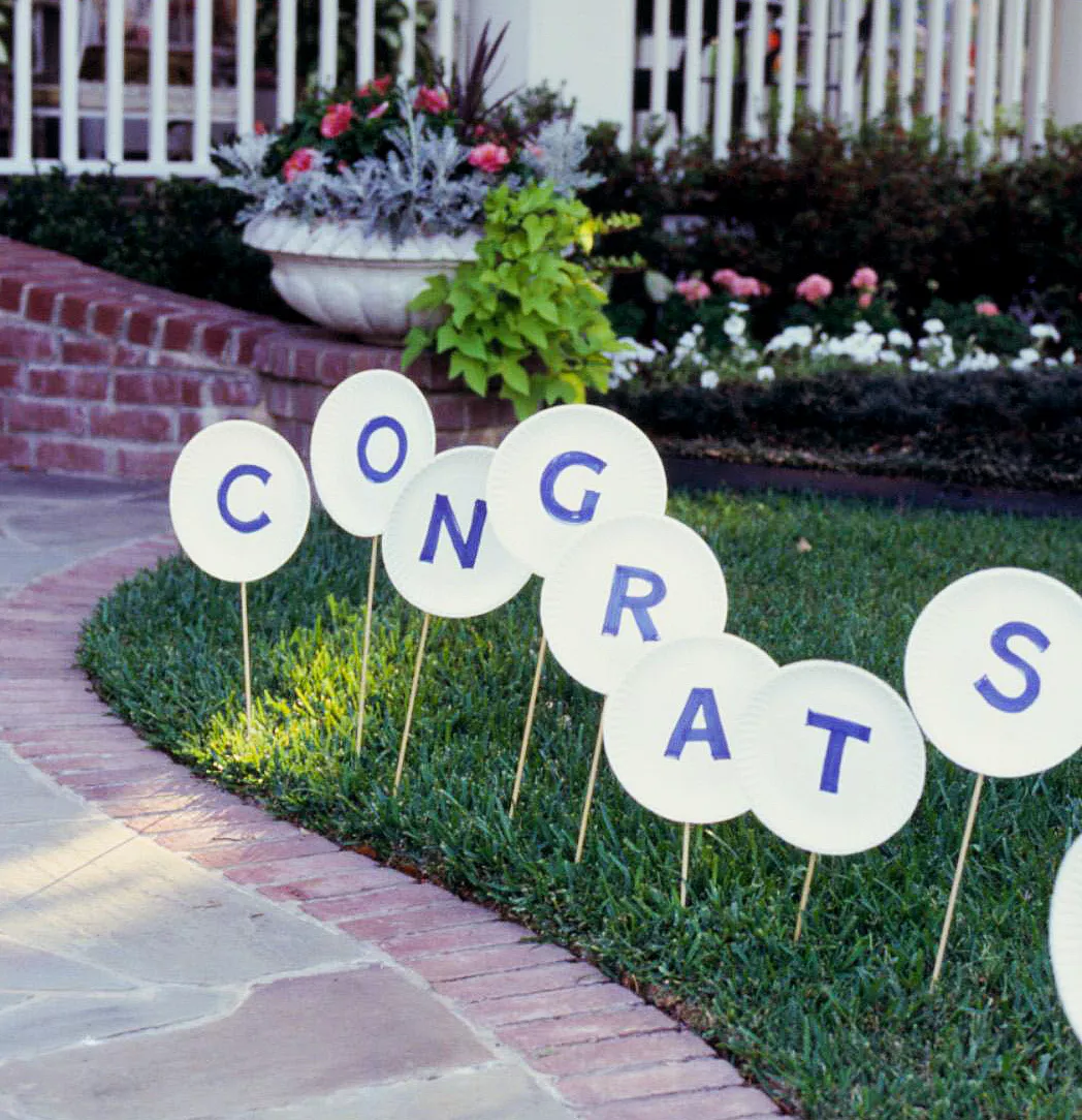 congrats spelled on paper plates on lawn