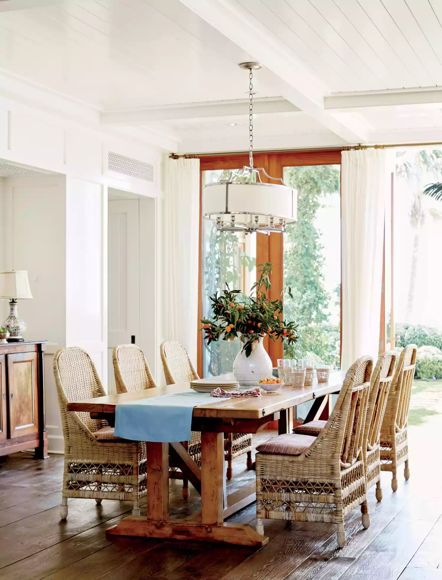 Organic, unpolished pieces mirror the beach's raw beauty. "Rustic wood furniture implies ease of use," says Clarke. He had the dining table made locally using old wood. "You never want to design a home that feels too precious to really live in, especially