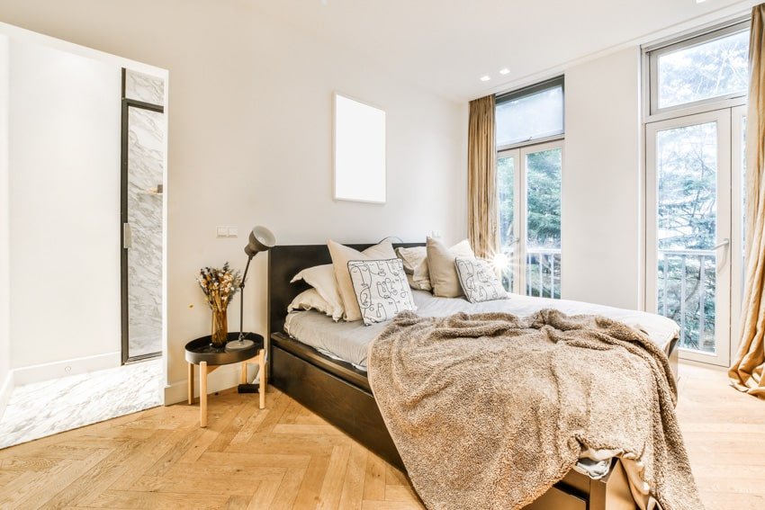 Bedroom with wood floors and gold blanket